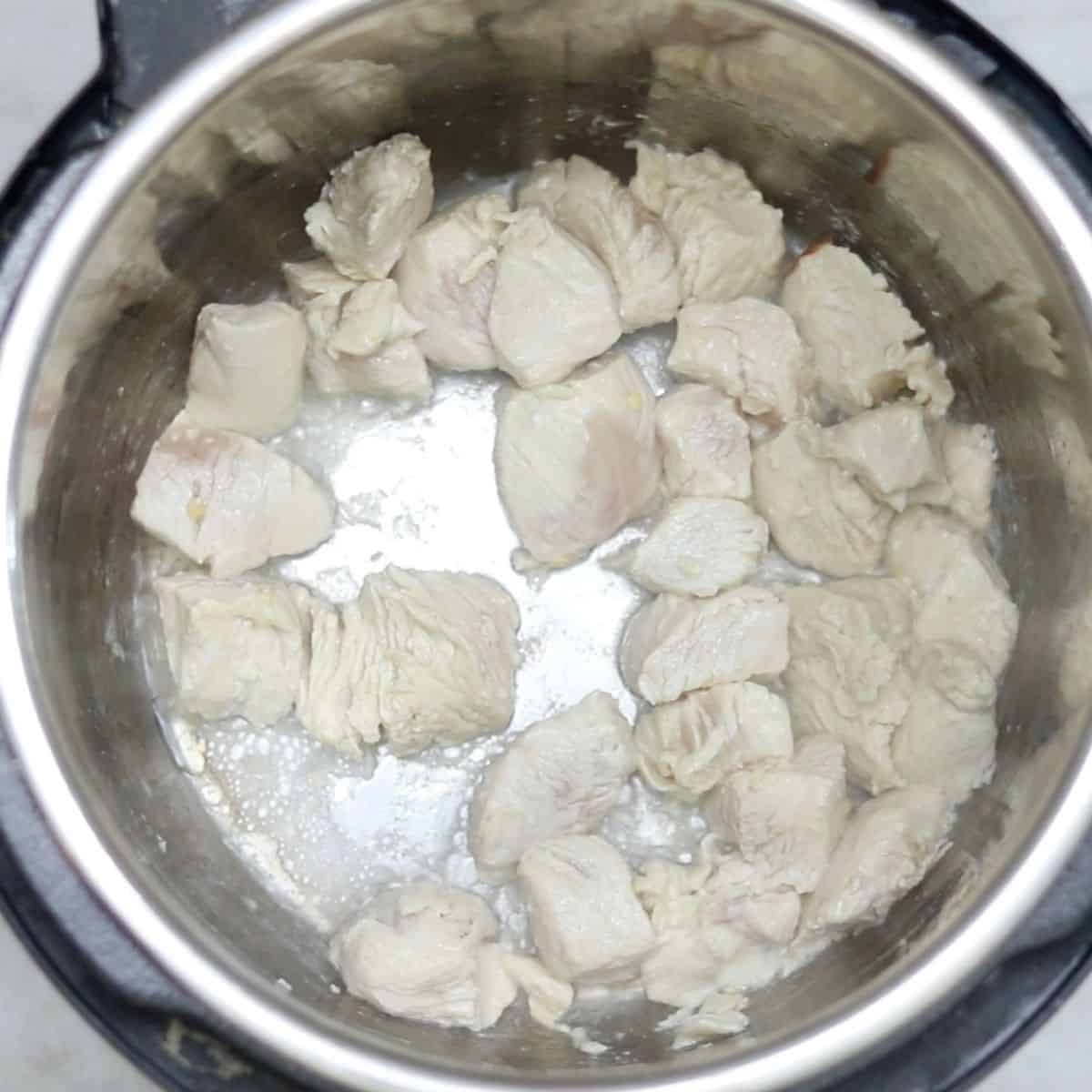 Sauteed chicken inside inner pot of instant pot. 