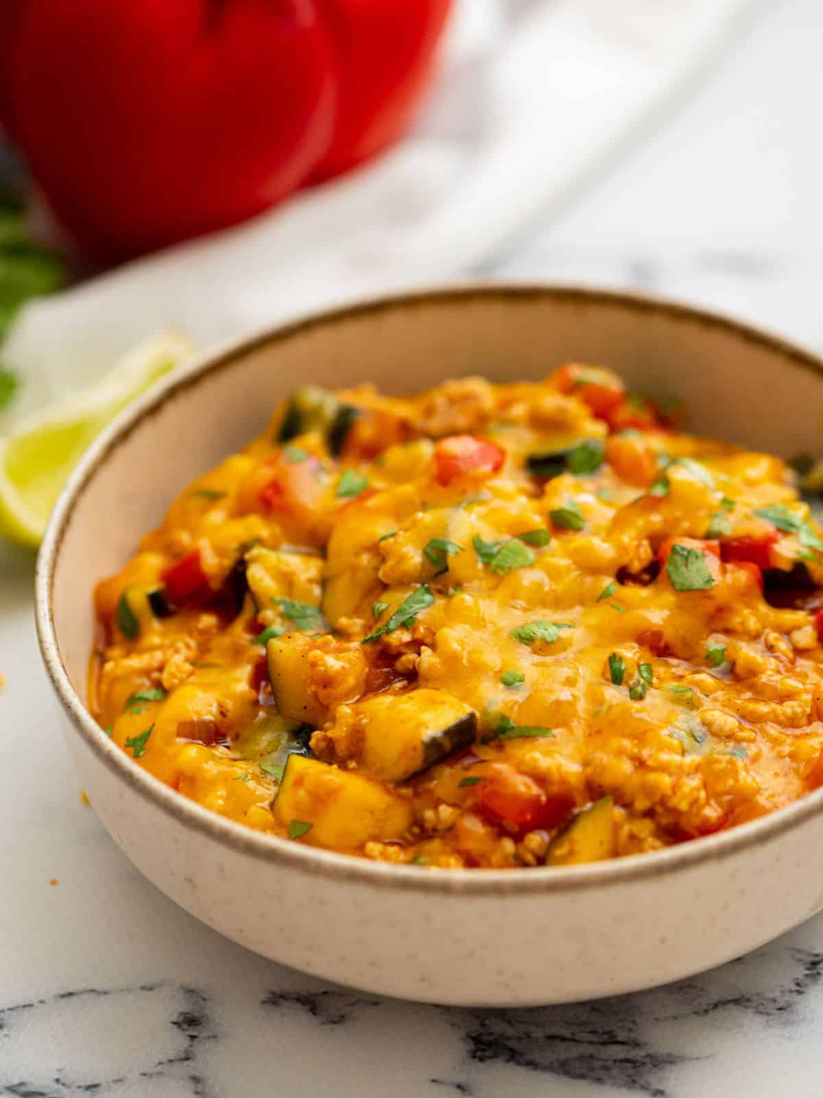 Bowl of cheesy taco skillet recipe in a large bowl topped with cilantro.