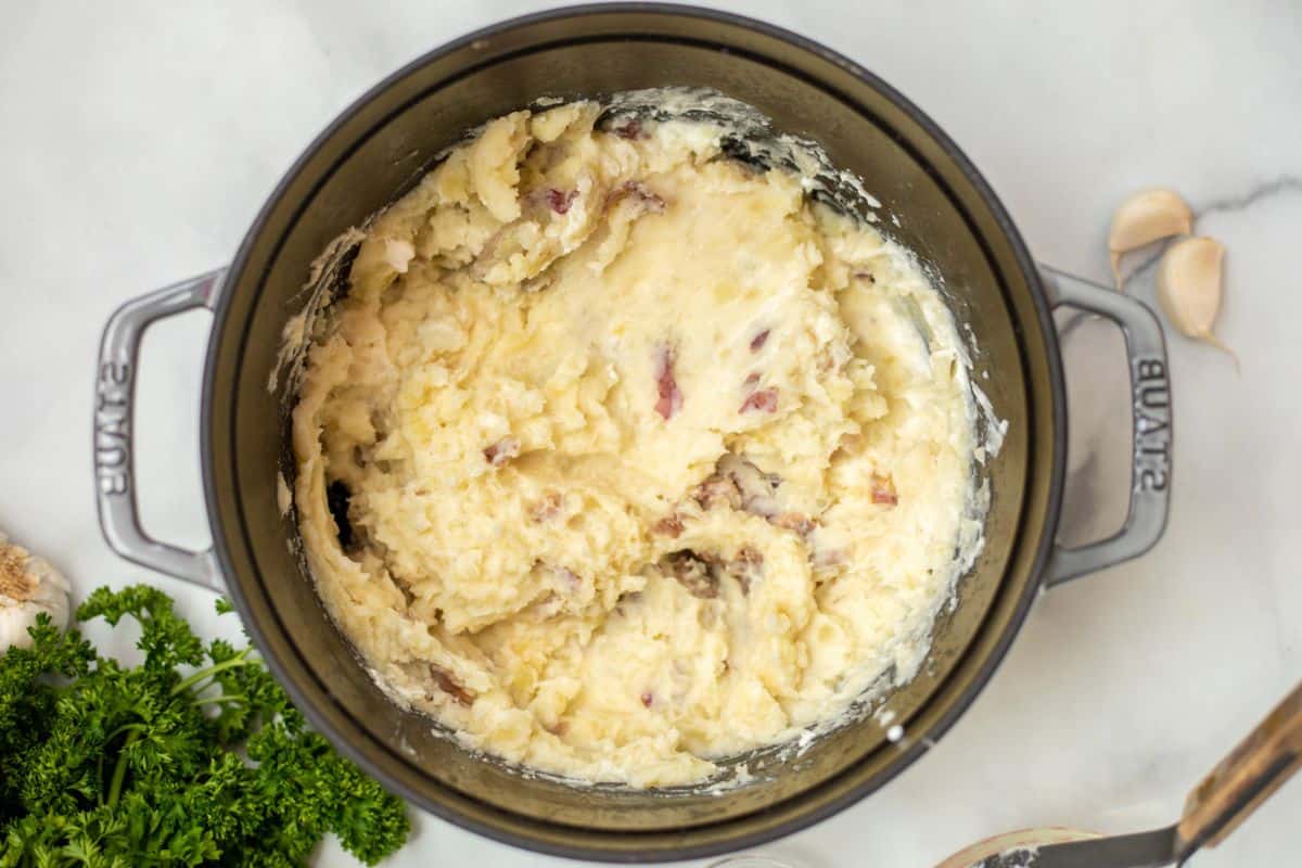 Mashed red potatoes with skin in heavy-duty pan.