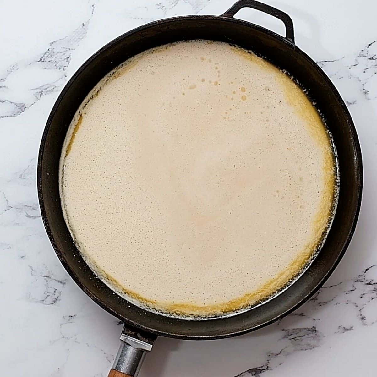 Pancake batter in skillet.