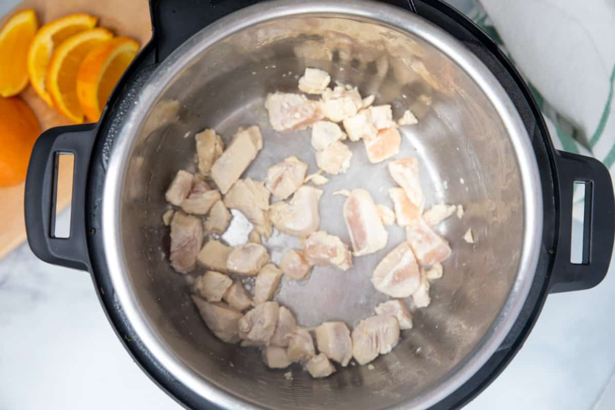 Sauteed chicken inside inner pot of instant pot. 