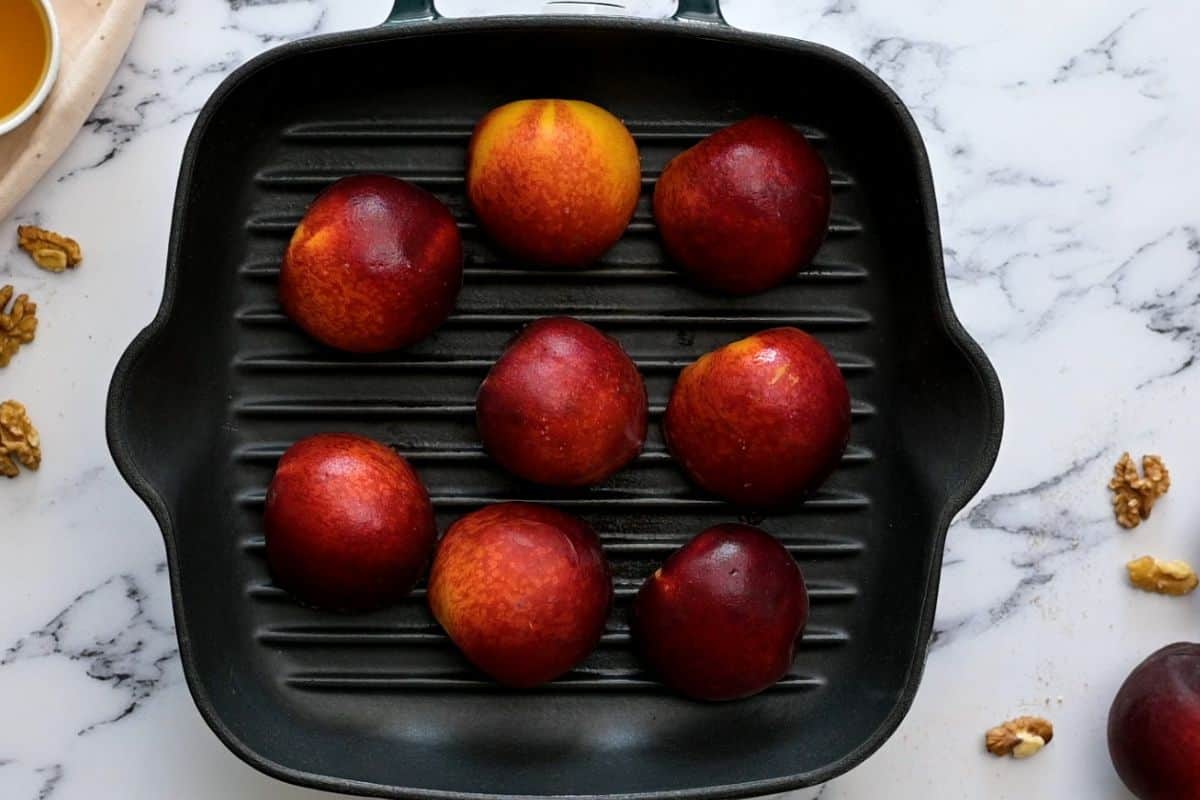 Peaches cut in half, flesh side down on grill pan.