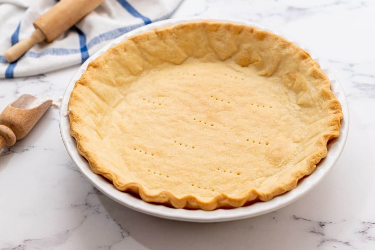 Butter pie crust baked in white pie pan. 
