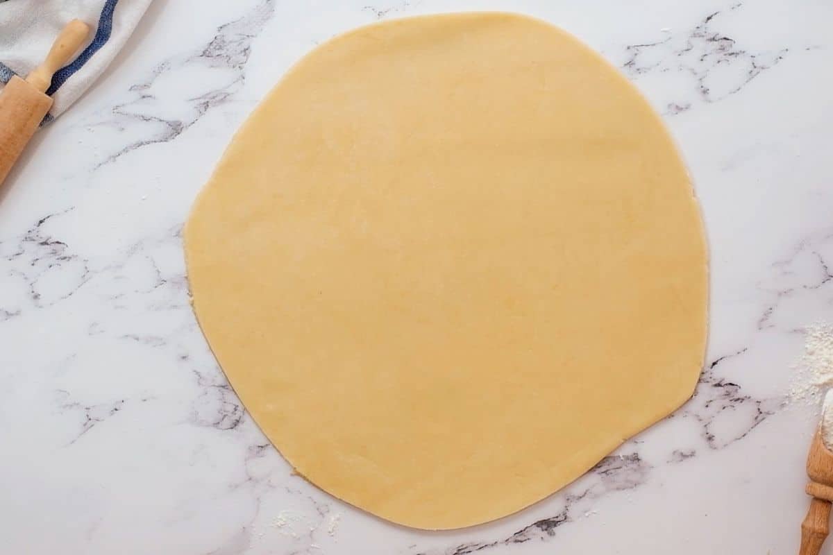 Pie dough rolled out to 12 inch circle on counter. 
