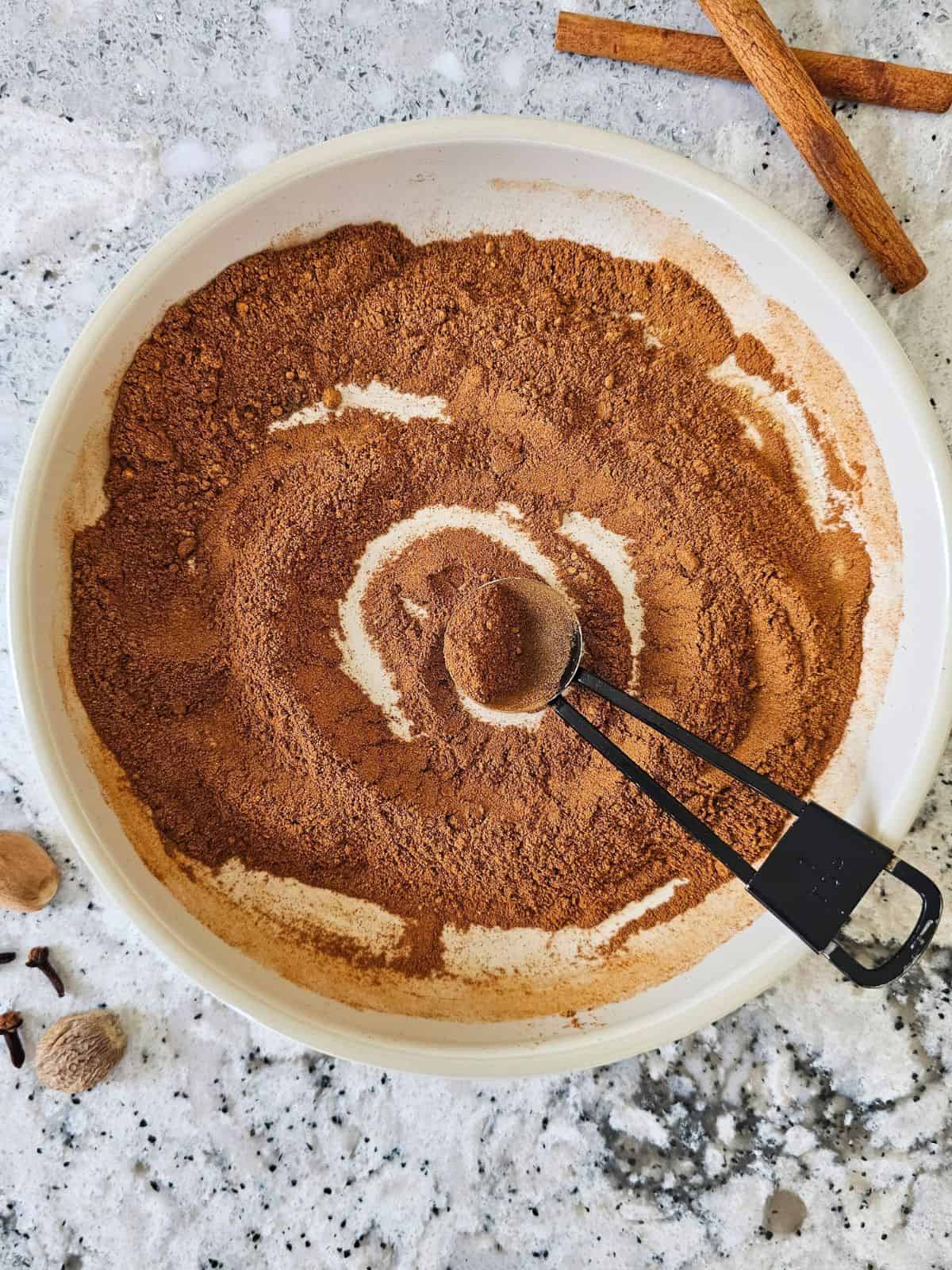 Ingredients for pumpkin pie spice blend whisked together in a small bowl.