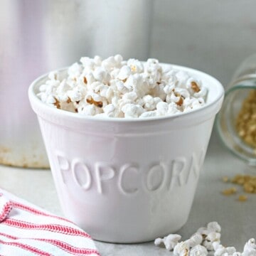 Homemade Stovetop Popcorn in white bowl labeled popcorn.