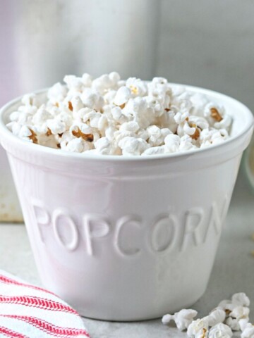 Homemade Stovetop Popcorn in white bowl labeled popcorn.
