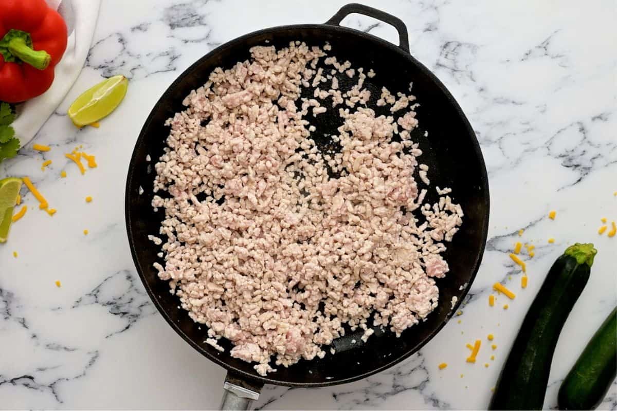 Ground turkey cooked in the skillet.