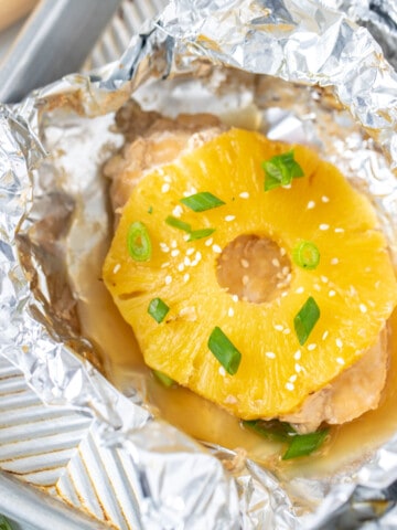 Chicken Teriyaki in foil packet topped with pineapple.