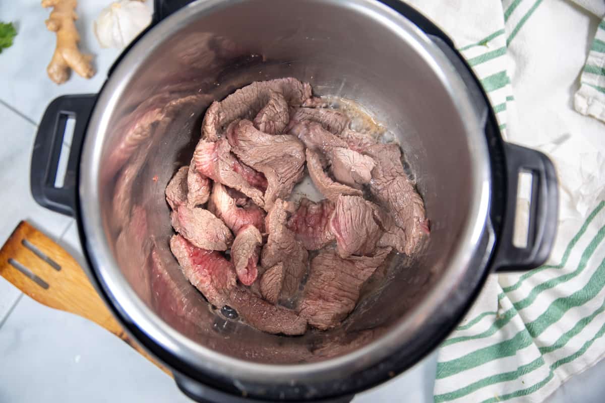 Seared beef in inner pot of Instant Pot. 