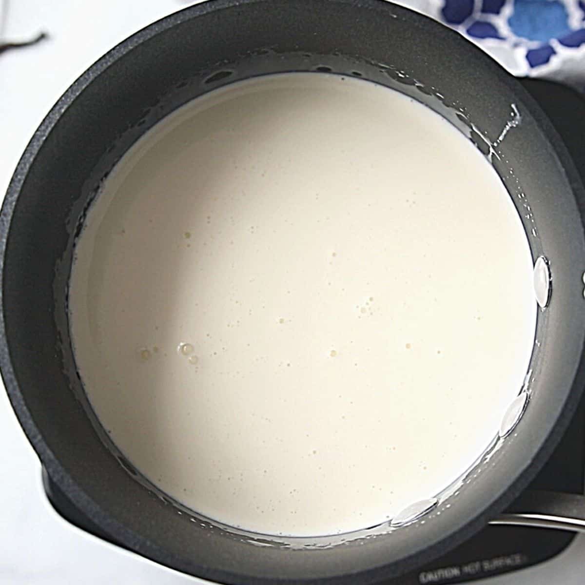 Cream in saucepan for homemade ice cream. 