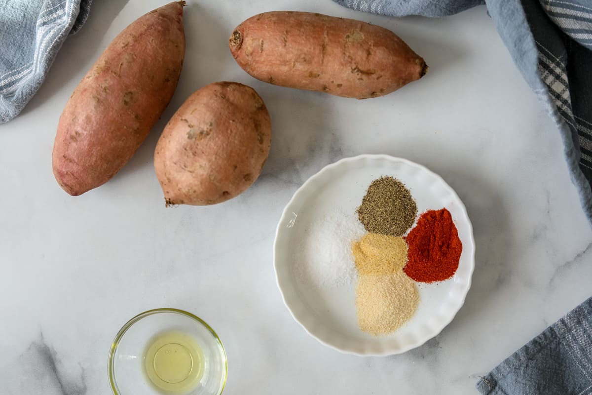 Ingredients needed to make Air Fryer Sweet Potatoes on counter. 
