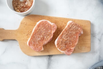 2 boneless pork chops seasoned with dry rub.
