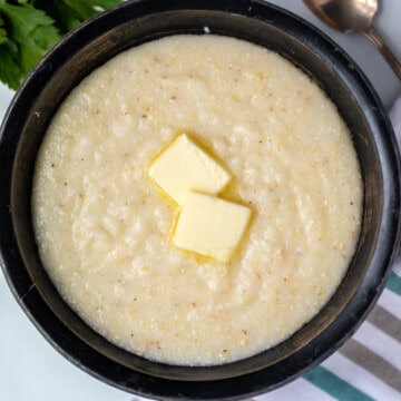 Bowl of homemade grits with a pat of butter.
