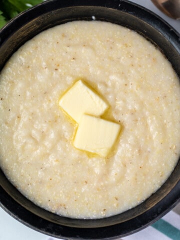 Bowl of homemade grits with a pat of butter.