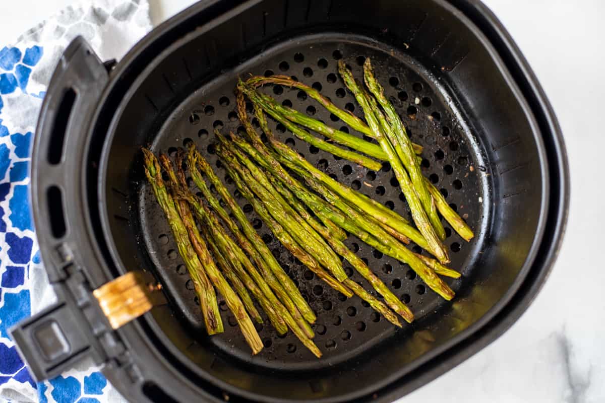 Roasted Asparagus in the air fryer basket.