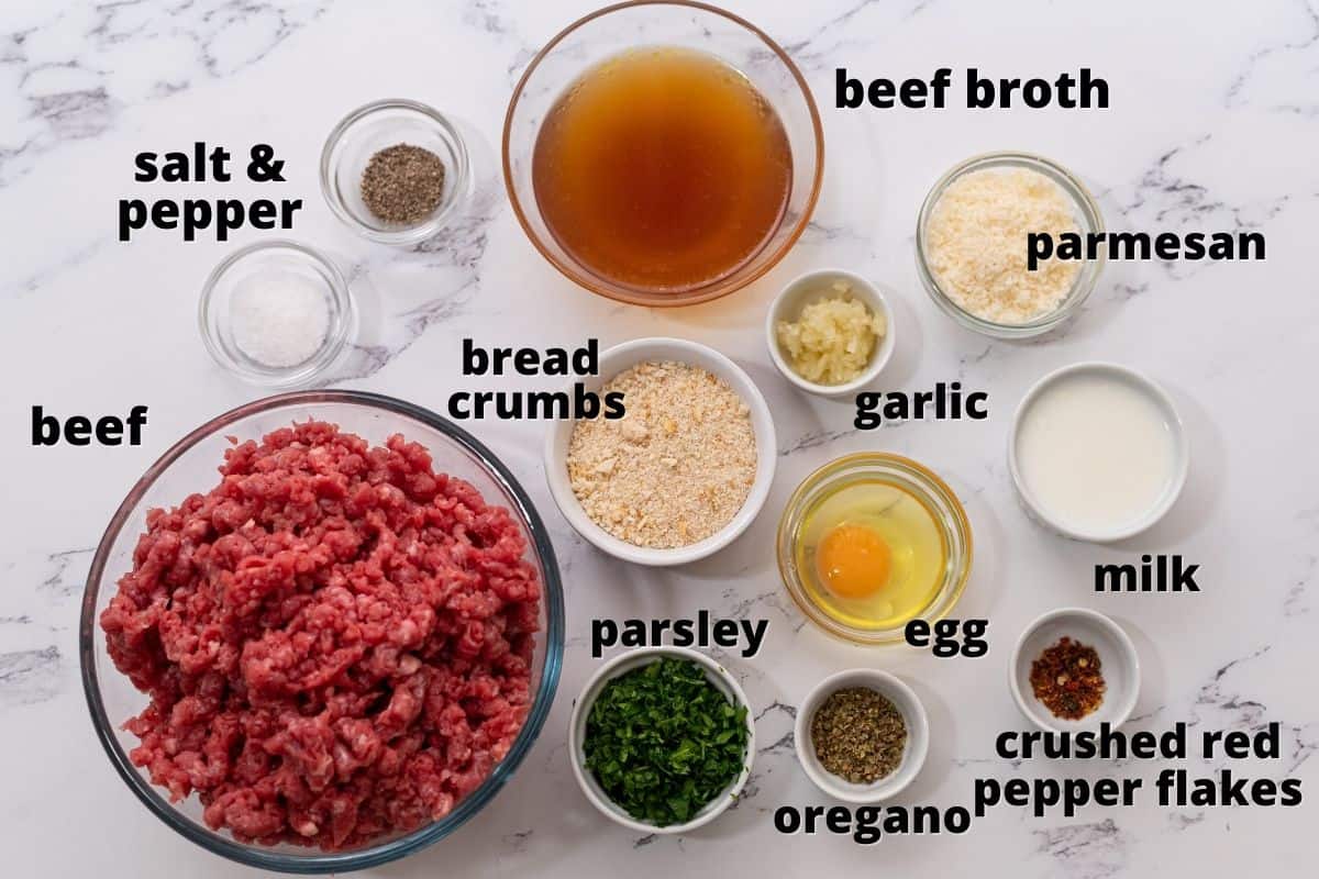 Ingredients for Meatballs labeled on white counter. 