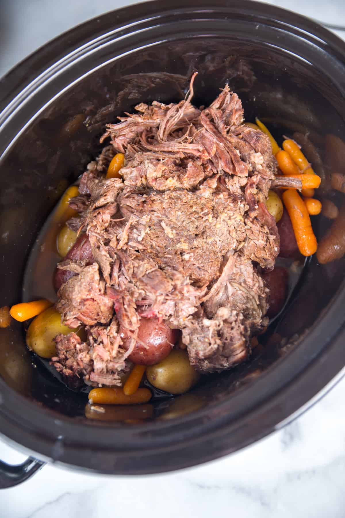 Cooked pot roast in the slow cooker. 