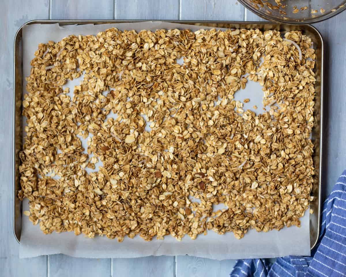 Toasted Granola on sheet pan with parchment paper. 