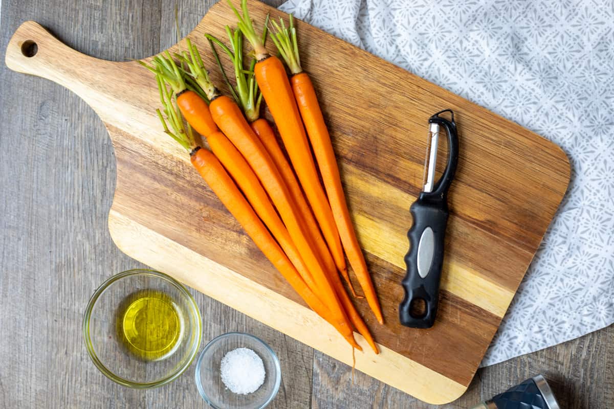 Peeled carrots on cutting board.