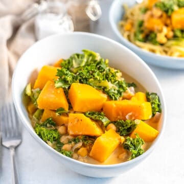Bowl of curry with butternut squash, chickpeas and kale.