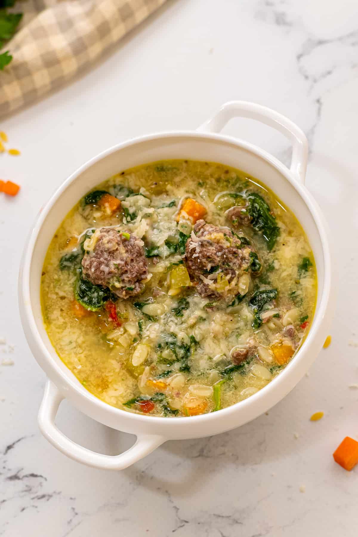 Bowl of wedding soup with meatballs. 