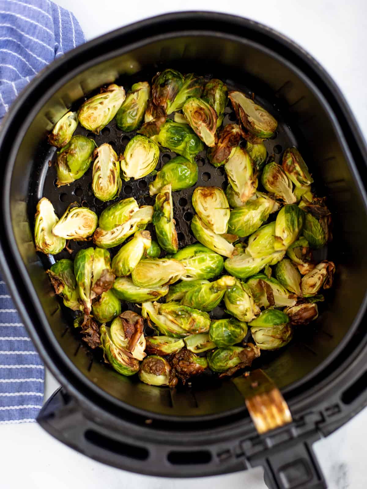 Brussels Sprouts in Air Fryer Basket. 