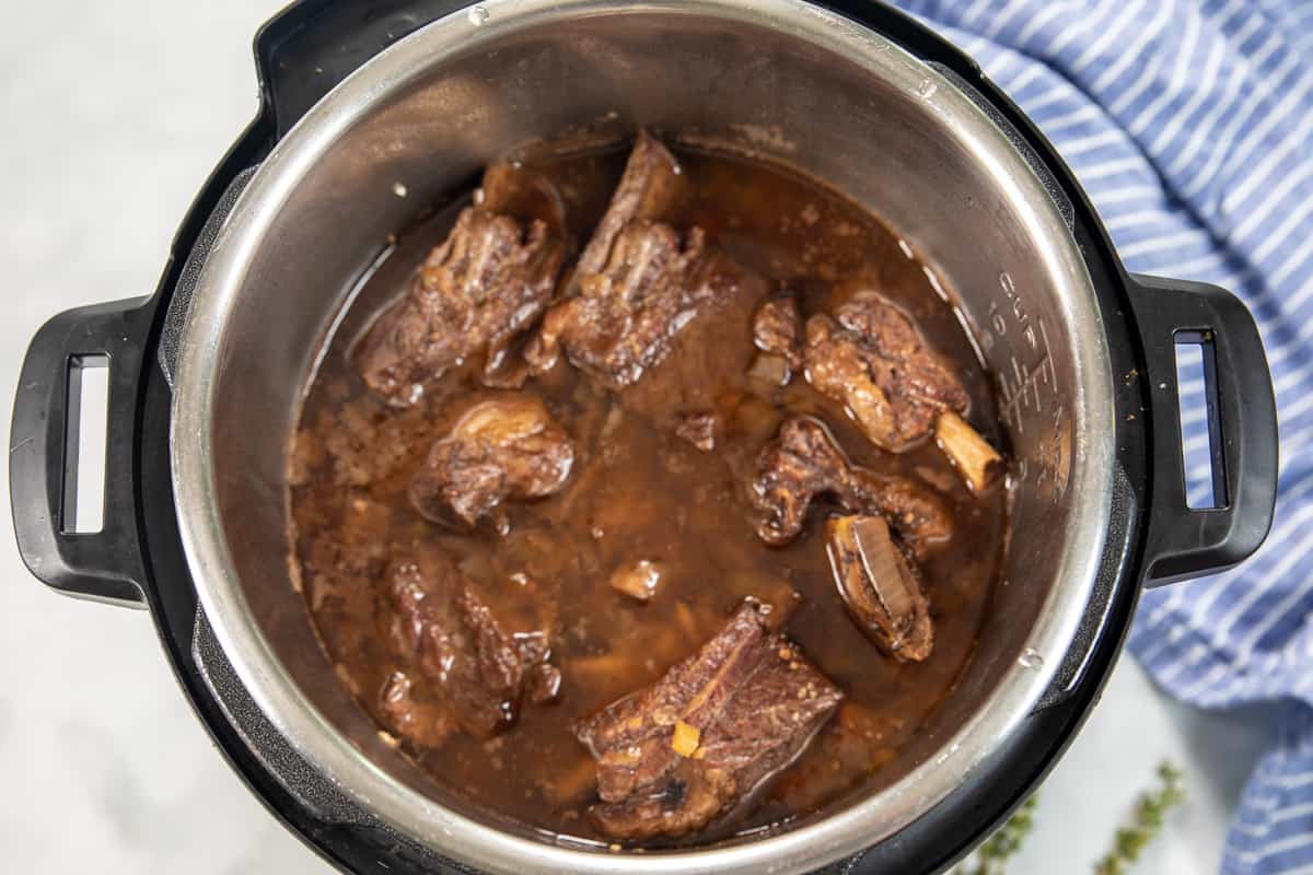 Short Ribs in inner pot of Instant Pot after pressure cooking. 