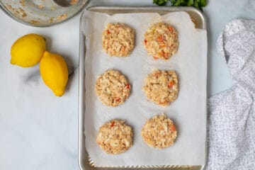 Shaped Crab Cakes on parchment lined baking sheet.