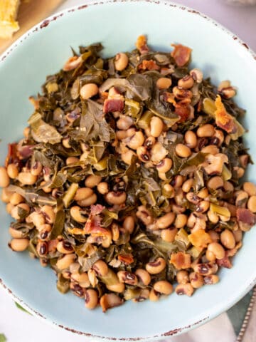 Instant Pot Black Eyed Peas with Greens in a blue serving dish.