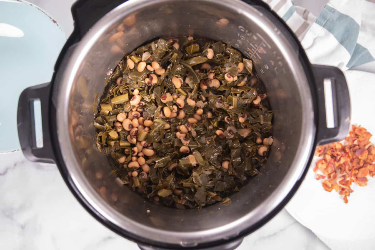Cooked black eyed peas and greens in inner pot.