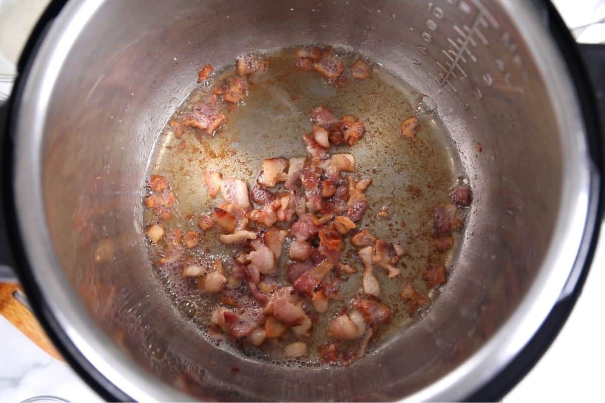 Browned Bacon in inner pot of Instant Pot. 