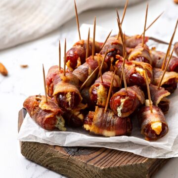 Tray of bacon wrapped dates stuffed with goat cheese and almonds.