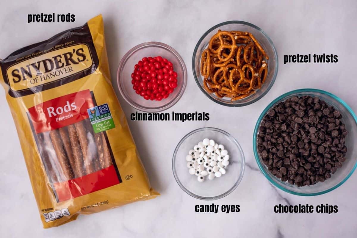 Ingredients for reindeer pretzels labeled on white counter. 