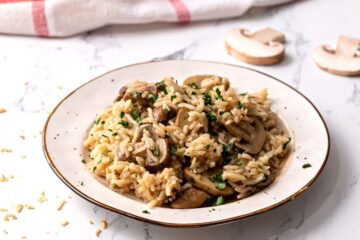 Rice Pilaf on plate with mushrooms and parsley.