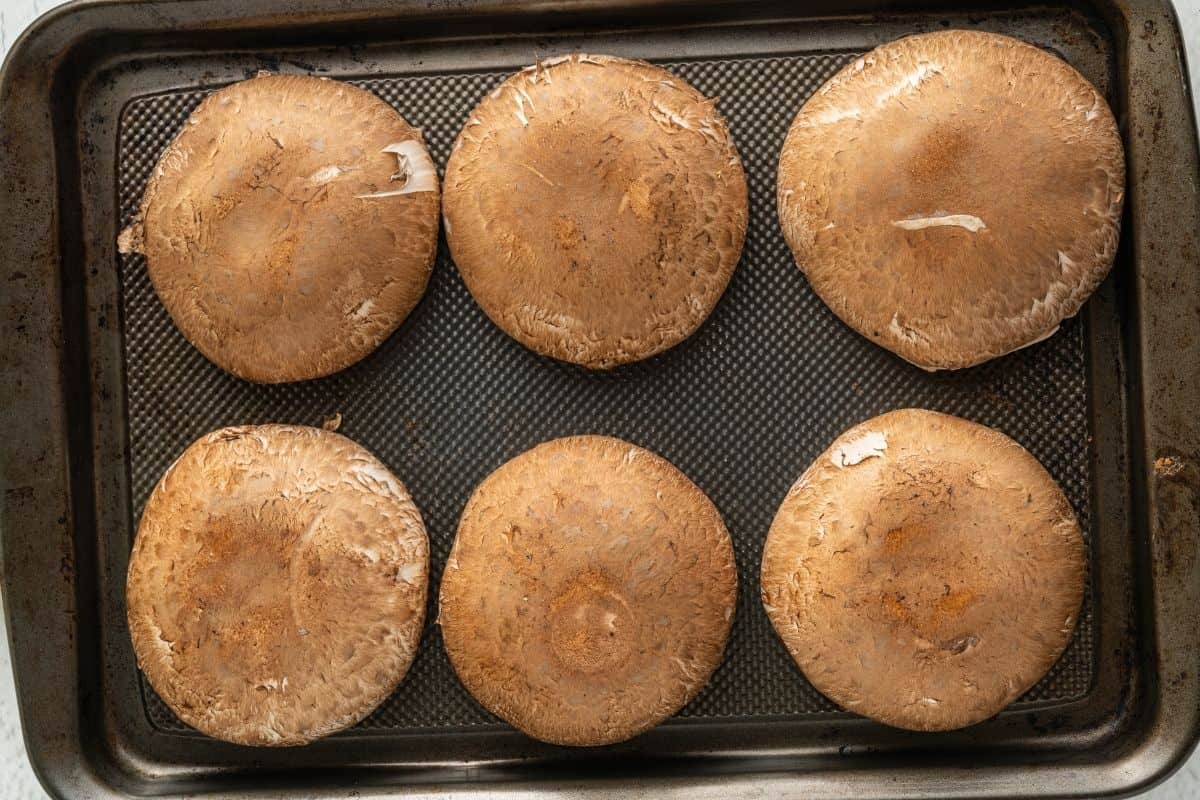 6 portobello mushrooms on sheet pan.