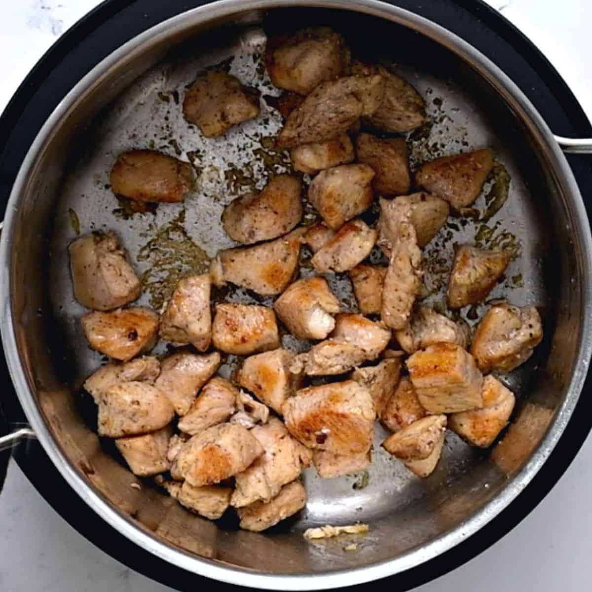Sauteed chicken in stock pot. 