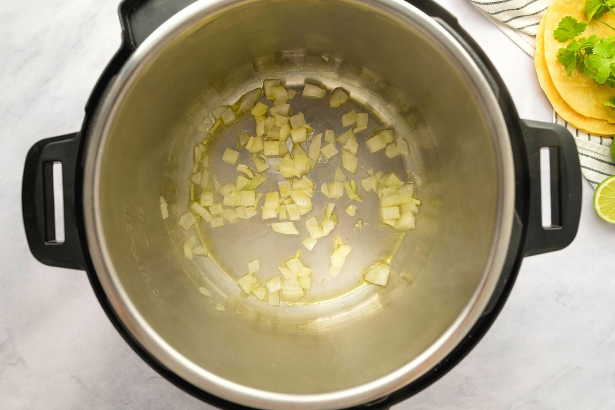 Sauteed onion in oil in inner pot.
