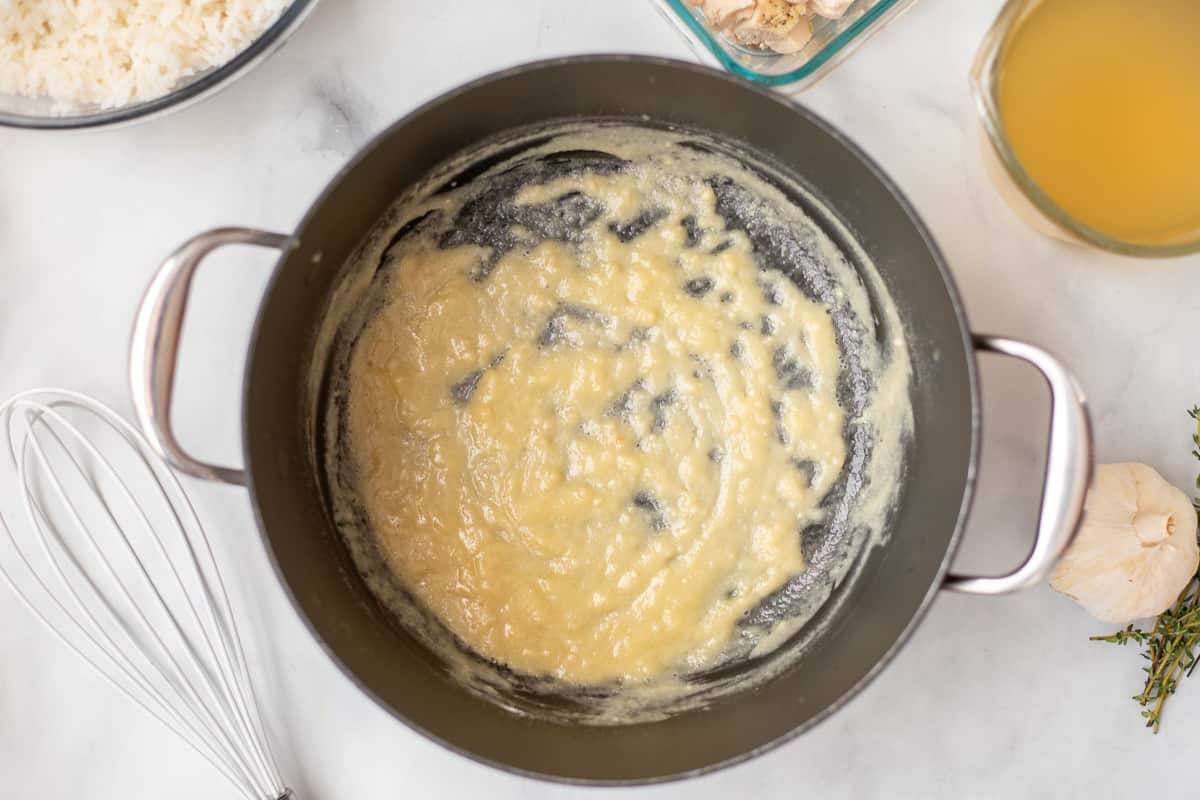 Roux for creamy cheesy chicken and rice in stock pan.