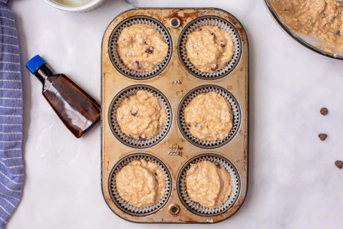 Oatmeal muffin batter evenly divided between 6 muffin tins. 