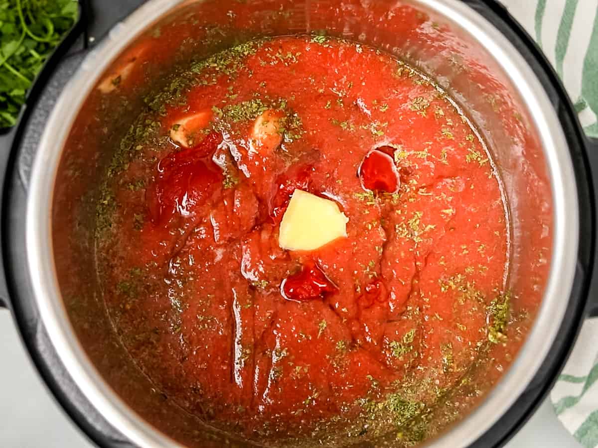 Ingredients for spaghetti sauce in instant pot before pressure cooking.