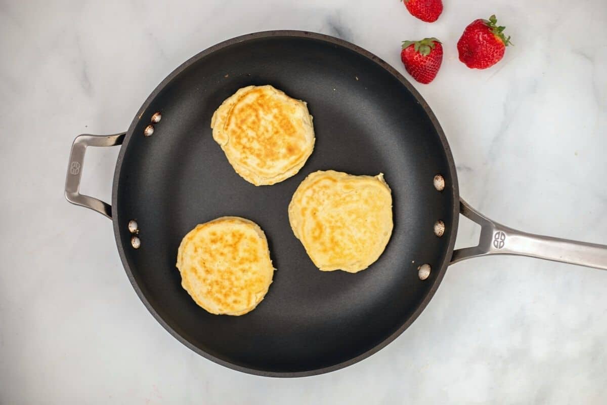 Cottage cheese pancakes in skillet.