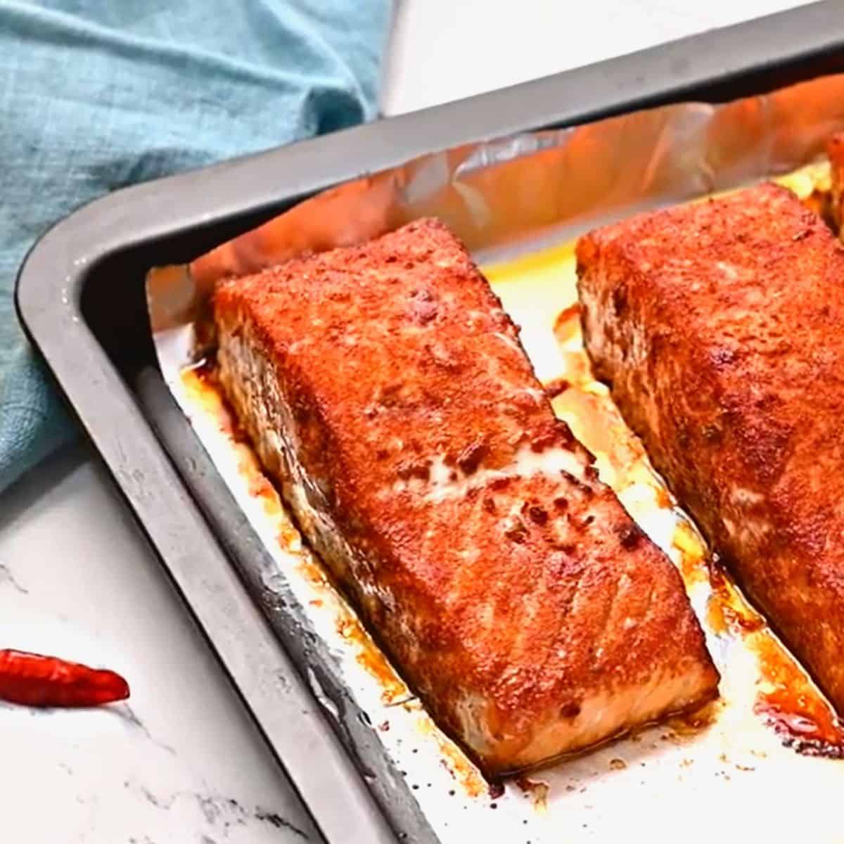 Baked spice rubbed salmon on baking sheet.