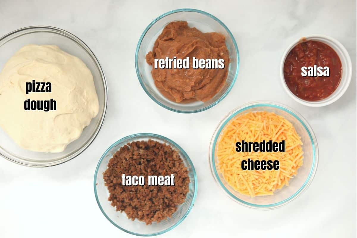 Ingredients for Taco Pizza labeled on counter.
