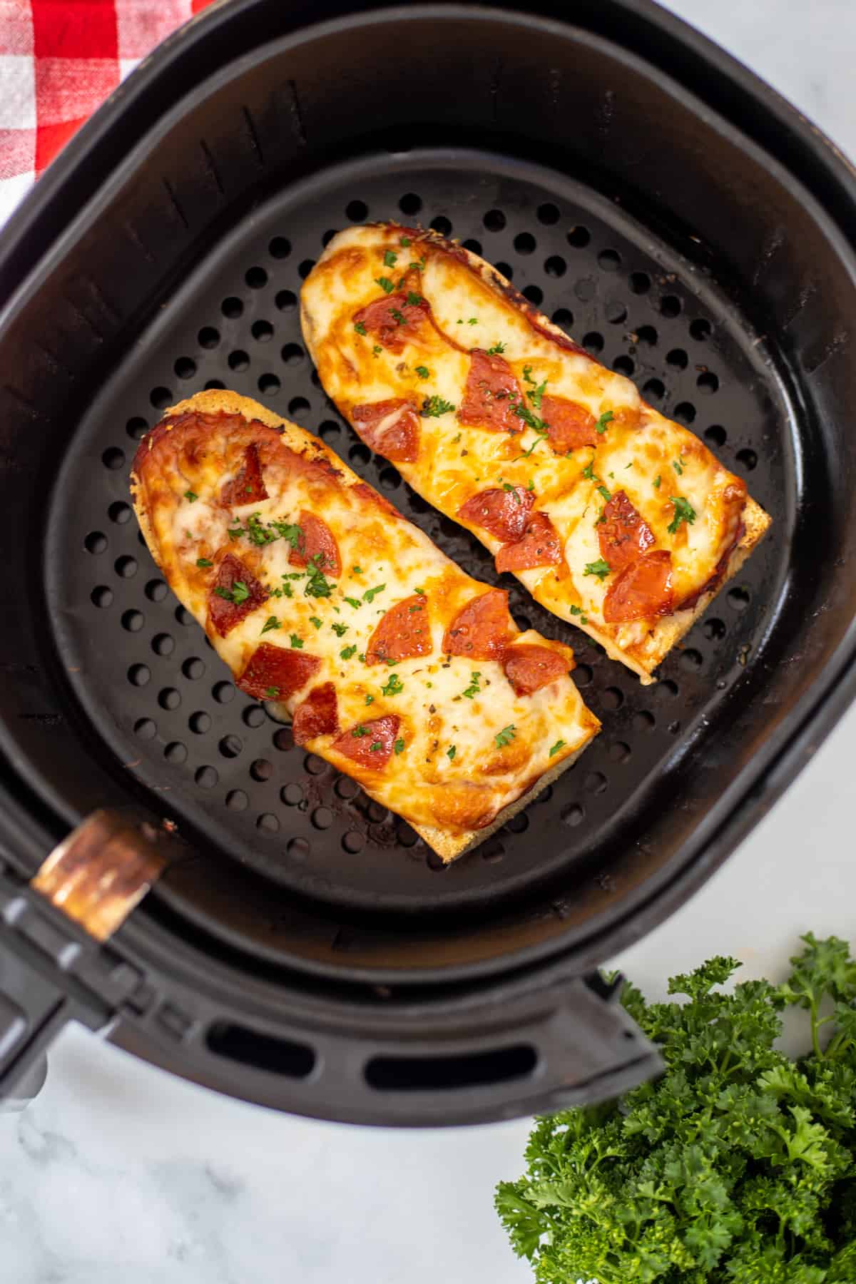 French Bread Pizza in air fryer after being cooked.