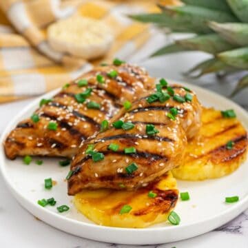 Grilled Teriyaki Chicken with grilled pineapple on white plate.
