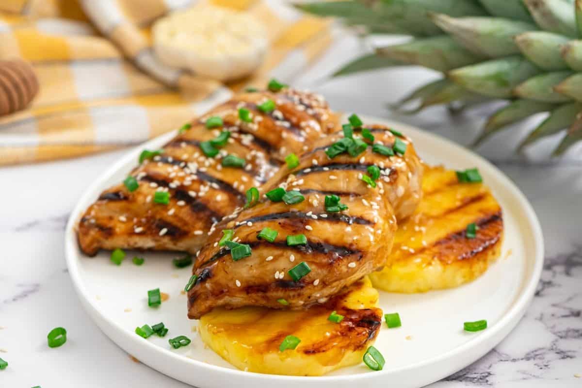 Grilled Teriyaki Chicken and grilled pineapple on white plate.