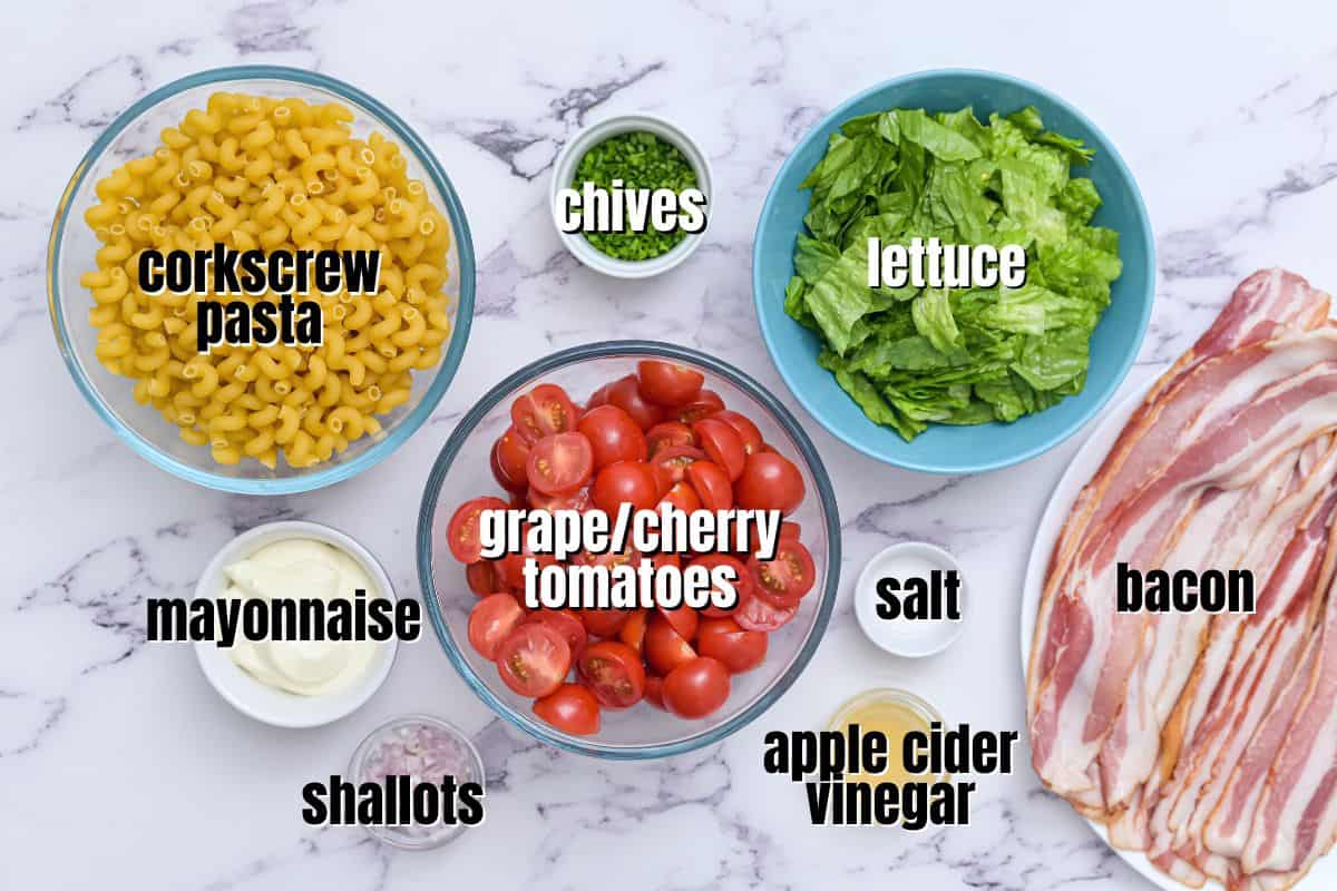 Ingredients for BLT pasta salad labled on counter.