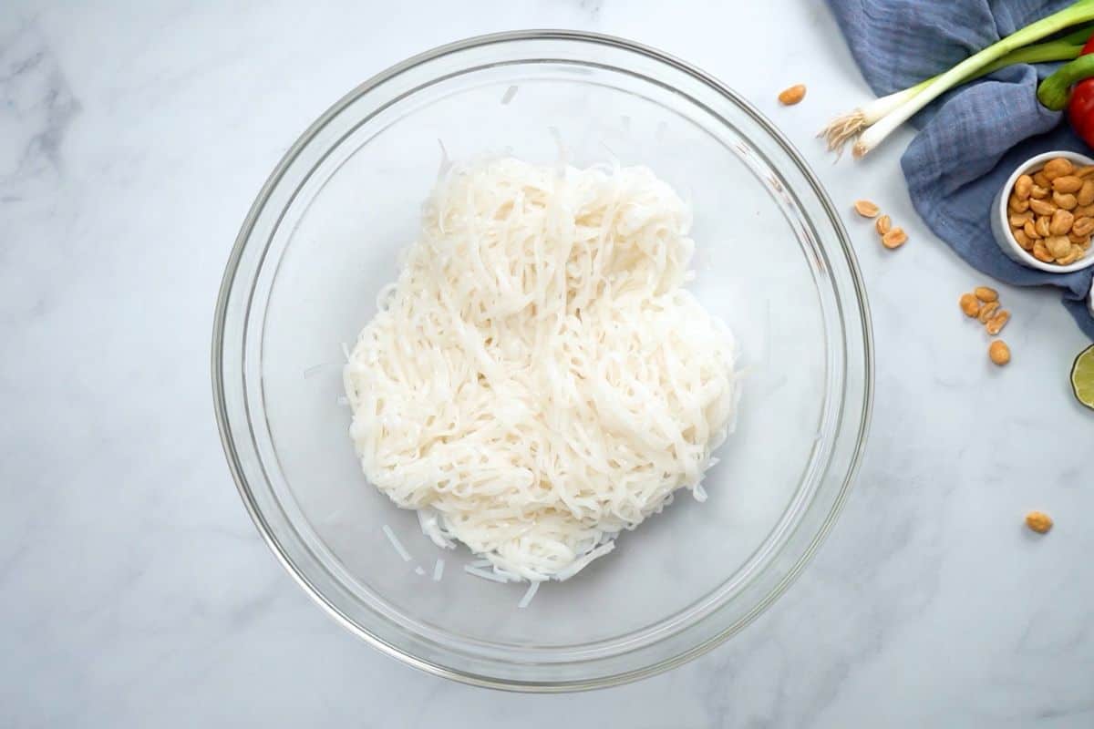 Bowl of rice noodles tossed with canola oil.