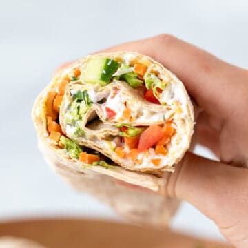 Veggie Wrap cut open showing vegetables and ranch.